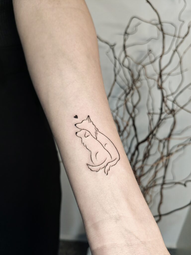 A minimalist fine line tattoo on the forearm depicting a sitting dog with a small heart above its head. A delicate and meaningful design, perfect for dog lovers or as a pet memorial tattoo. oplus_2097184