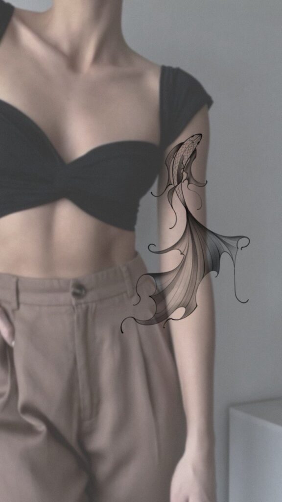 Fine line jellyfish tattoo design with flowing, organic lines and soft shading, placed on the upper arm. An elegant black and grey tattoo concept inspired by ocean forms, emphasizing movement and lightness. Tattoo design by Olga Sankova (olga_sankova_tattoo).