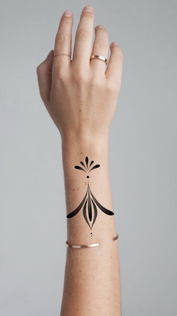 Minimalist ornamental tattoo design placed on the inner forearm, created in clean blackwork style. A symmetrical and elegant composition with fine lines and subtle decorative details, emphasizing balance and simplicity. Tattoo design by Olga Sankova (olga_sankova_tattoo).